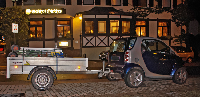 Photograph of Smart Fortwo car and attached trailer.